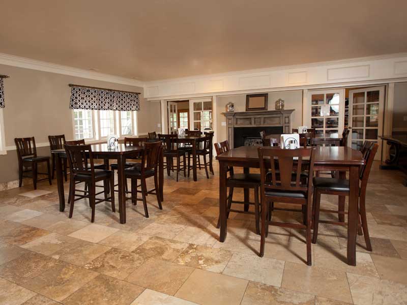 Dining room with wooden tables and tiled floor