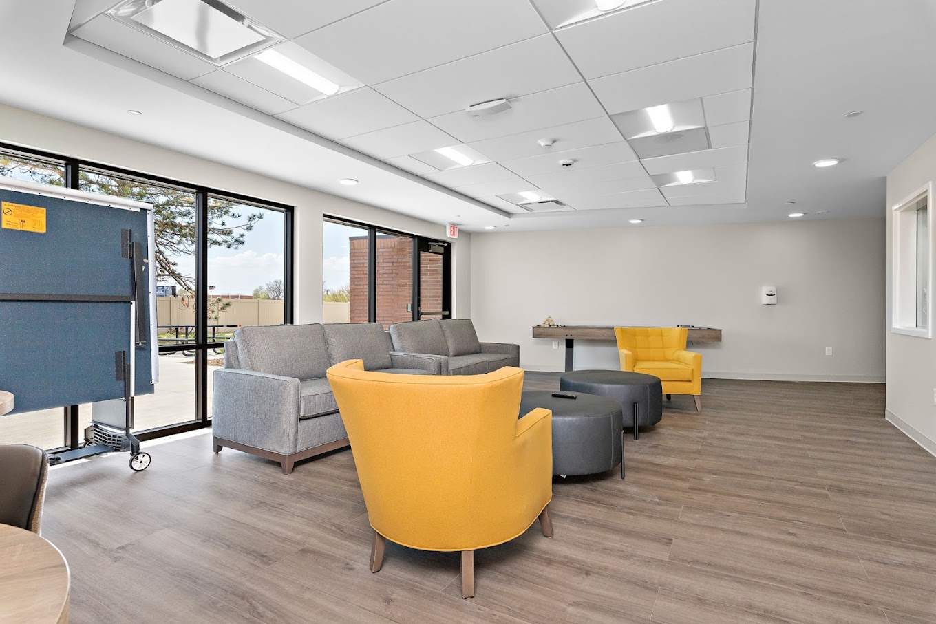 Lounge with gray sofas and yellow armchairs