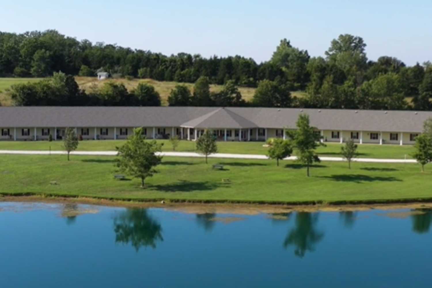 A scenic view of a lake surrounded by lush greenery and trees.