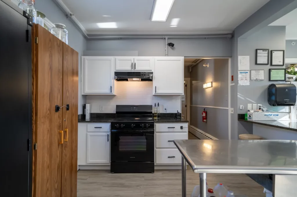 Shared kitchen with stove, cabinets, and prep space