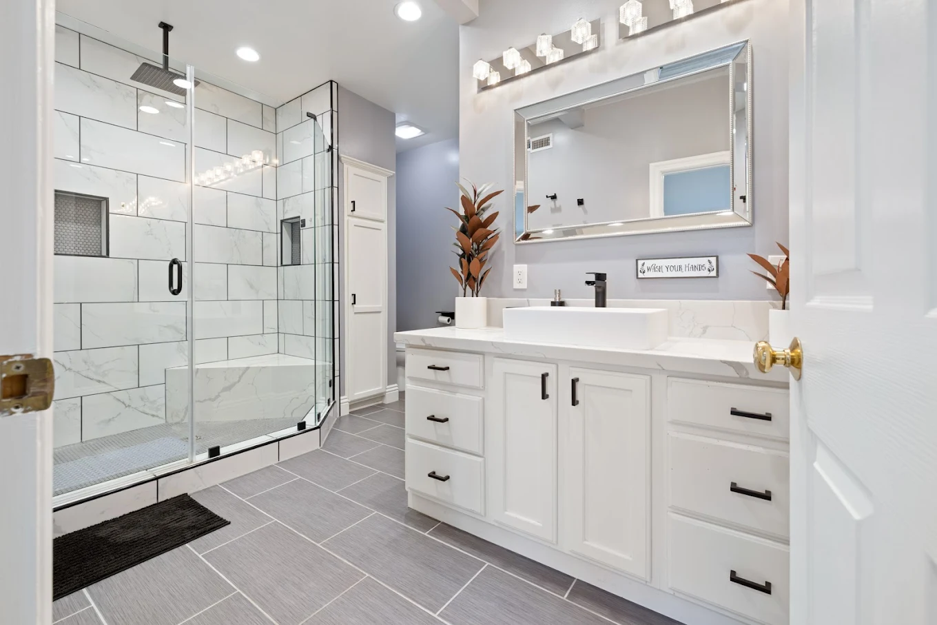 Modern bathroom with glass shower and marble countertops