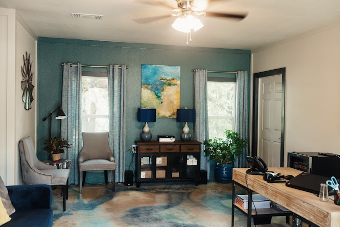 Therapy office with desk, chairs, and soft decor
