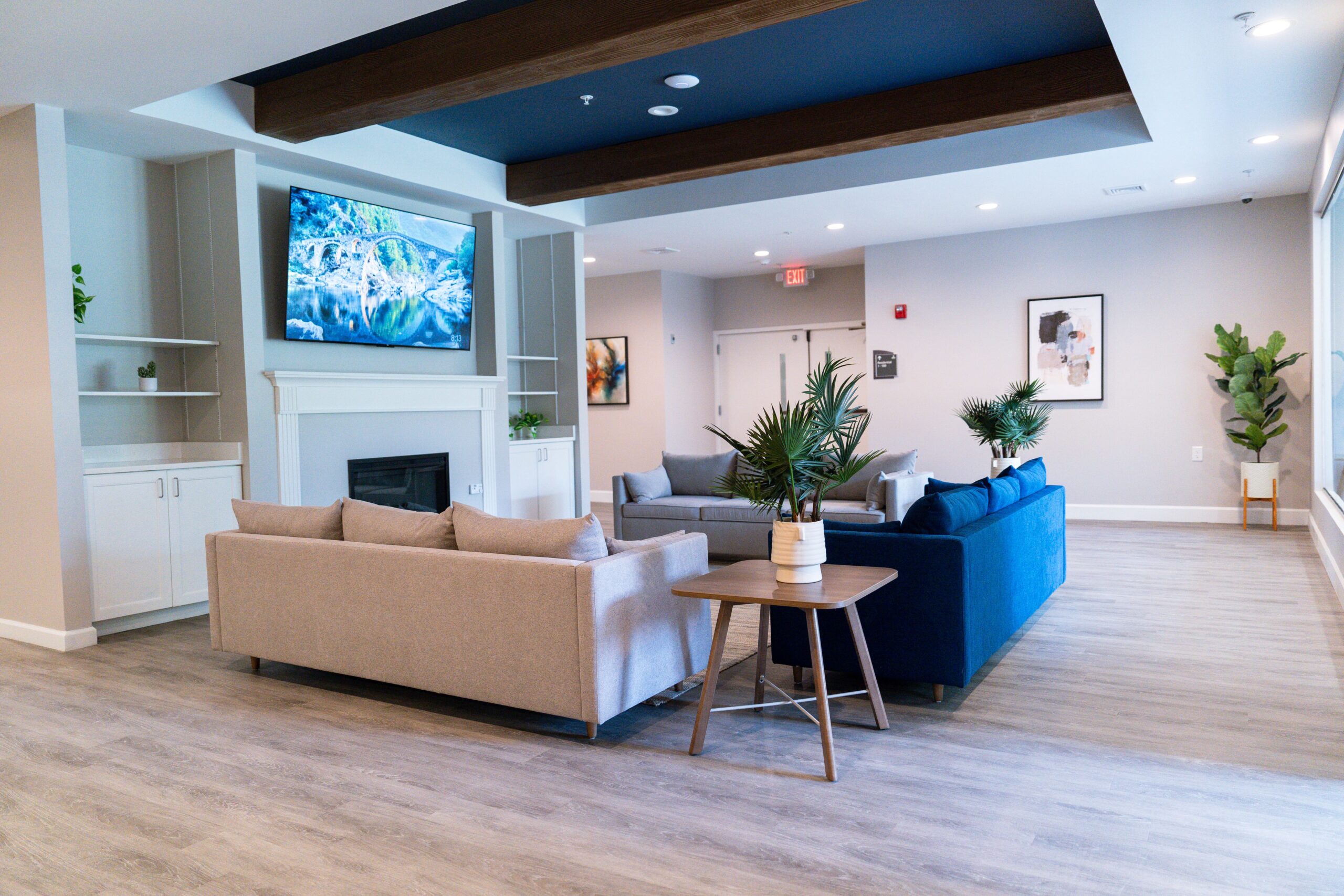 Lounge area featuring sofas, tables, and TV.