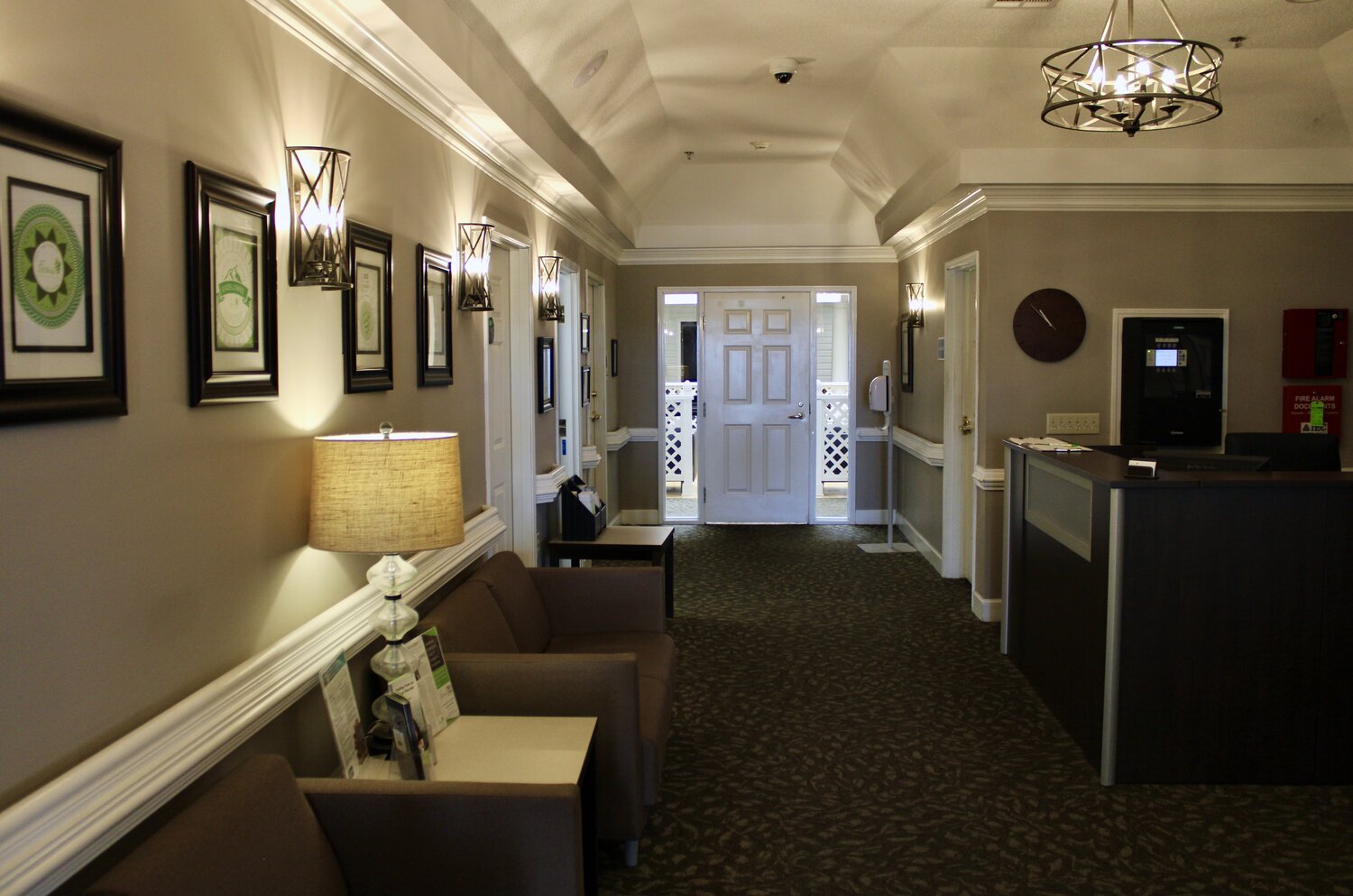 Reception desk and chairs in warmly lit hallway