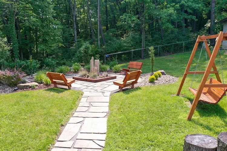 Landscaped courtyard with chairs and fire pit