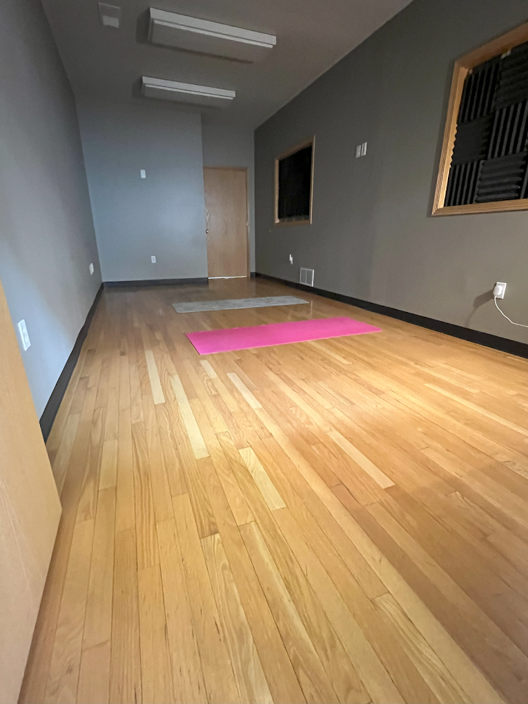 Wooden floor room with yoga mats for wellness therapy