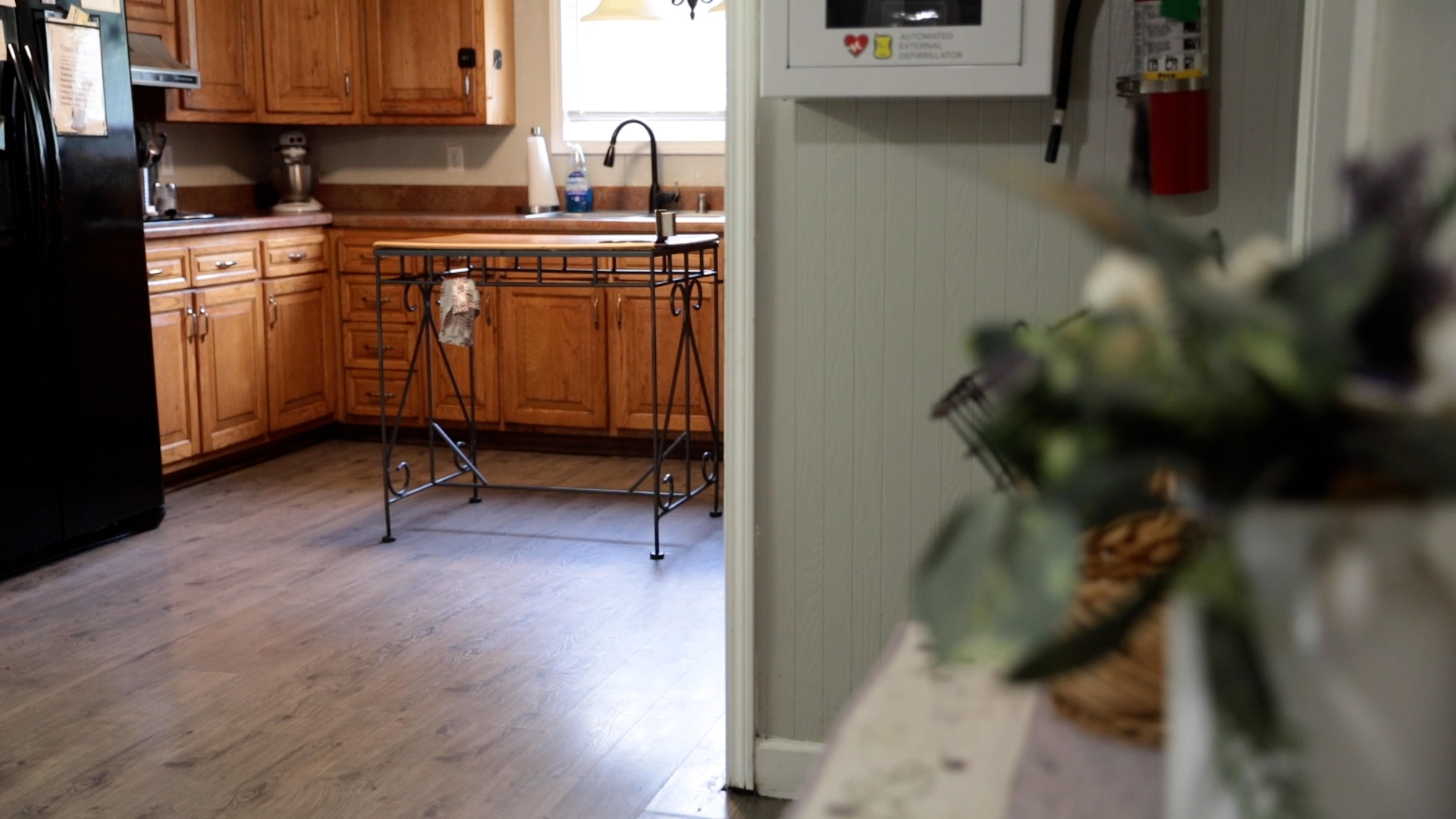 Kitchen with wood cabinets and a wrought iron island table