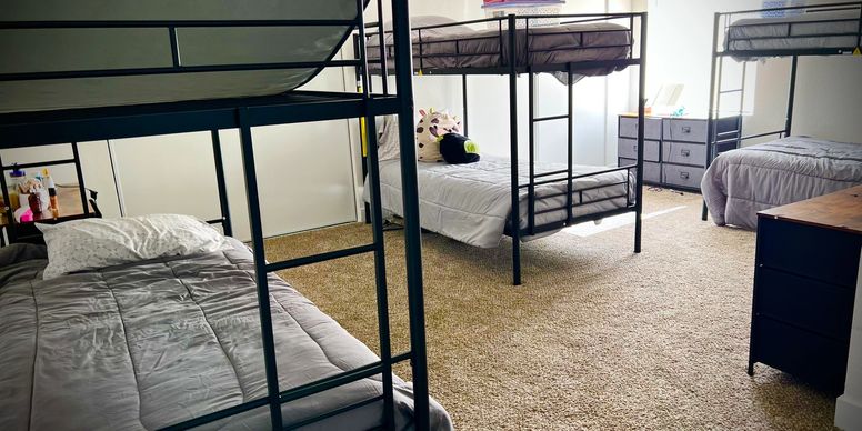 Shared bedroom with bunk beds and carpeted floor