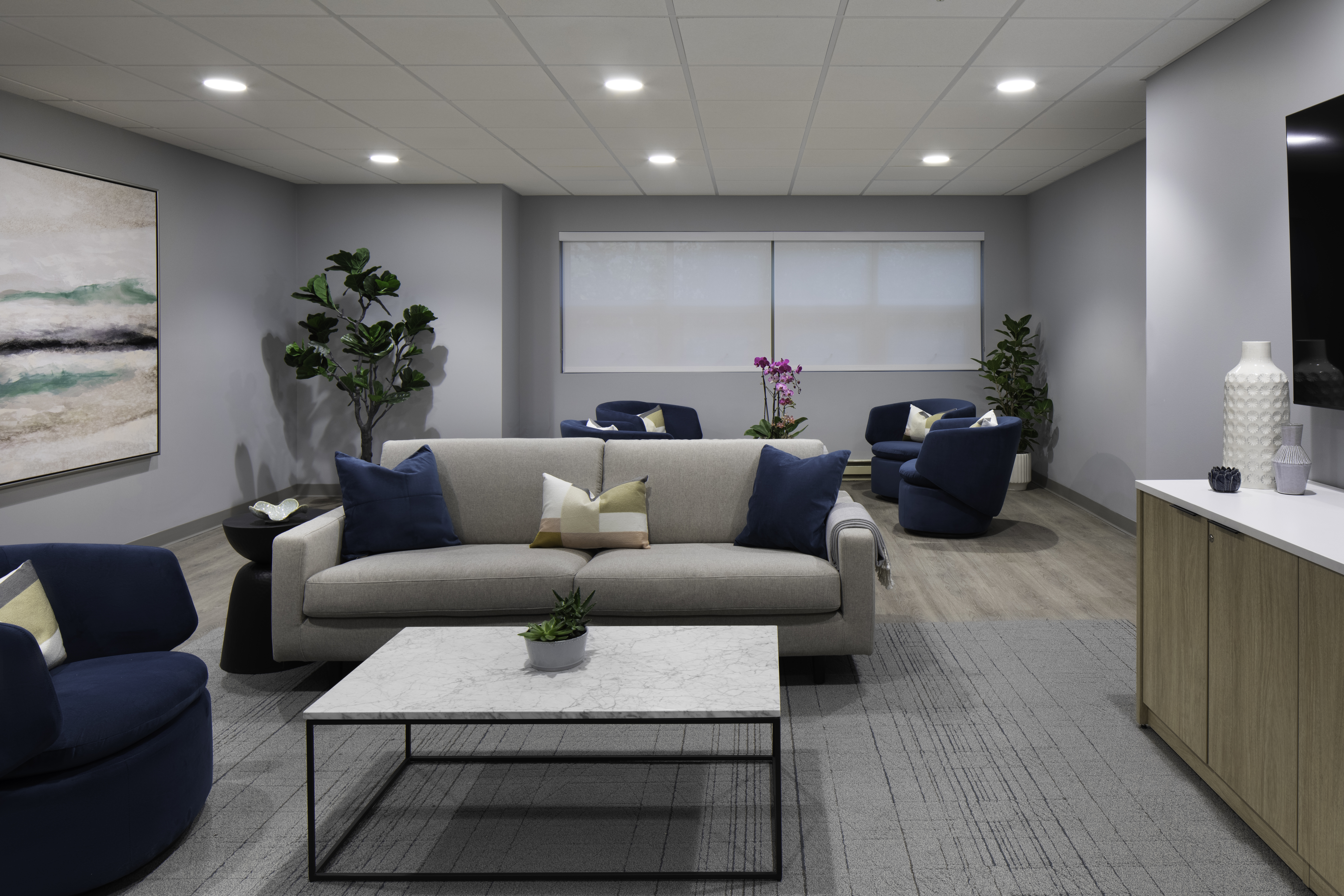 Couch and blue chairs in a cozy modern lounge