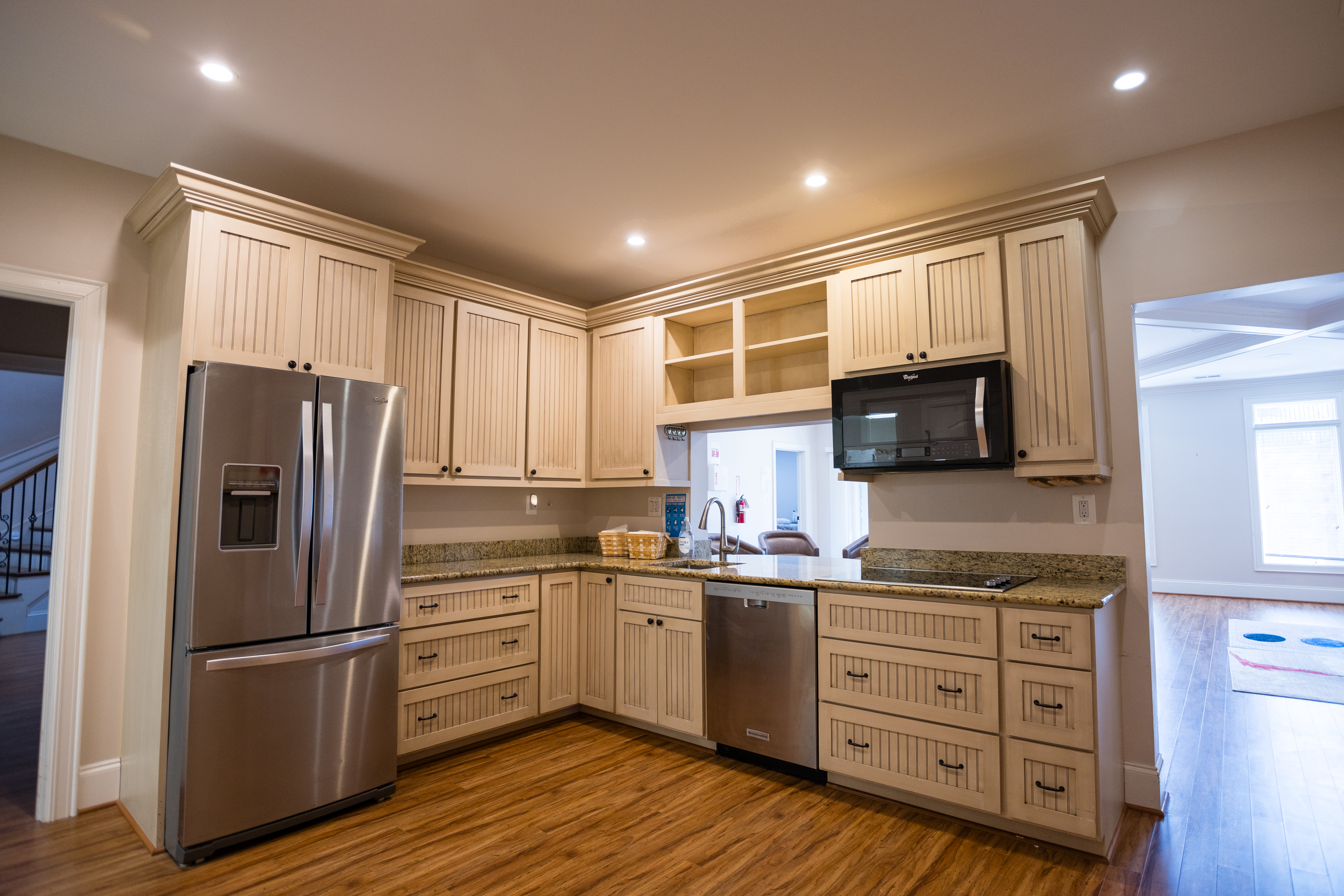 Rehab kitchen with wood cabinets and stainless steel fridge