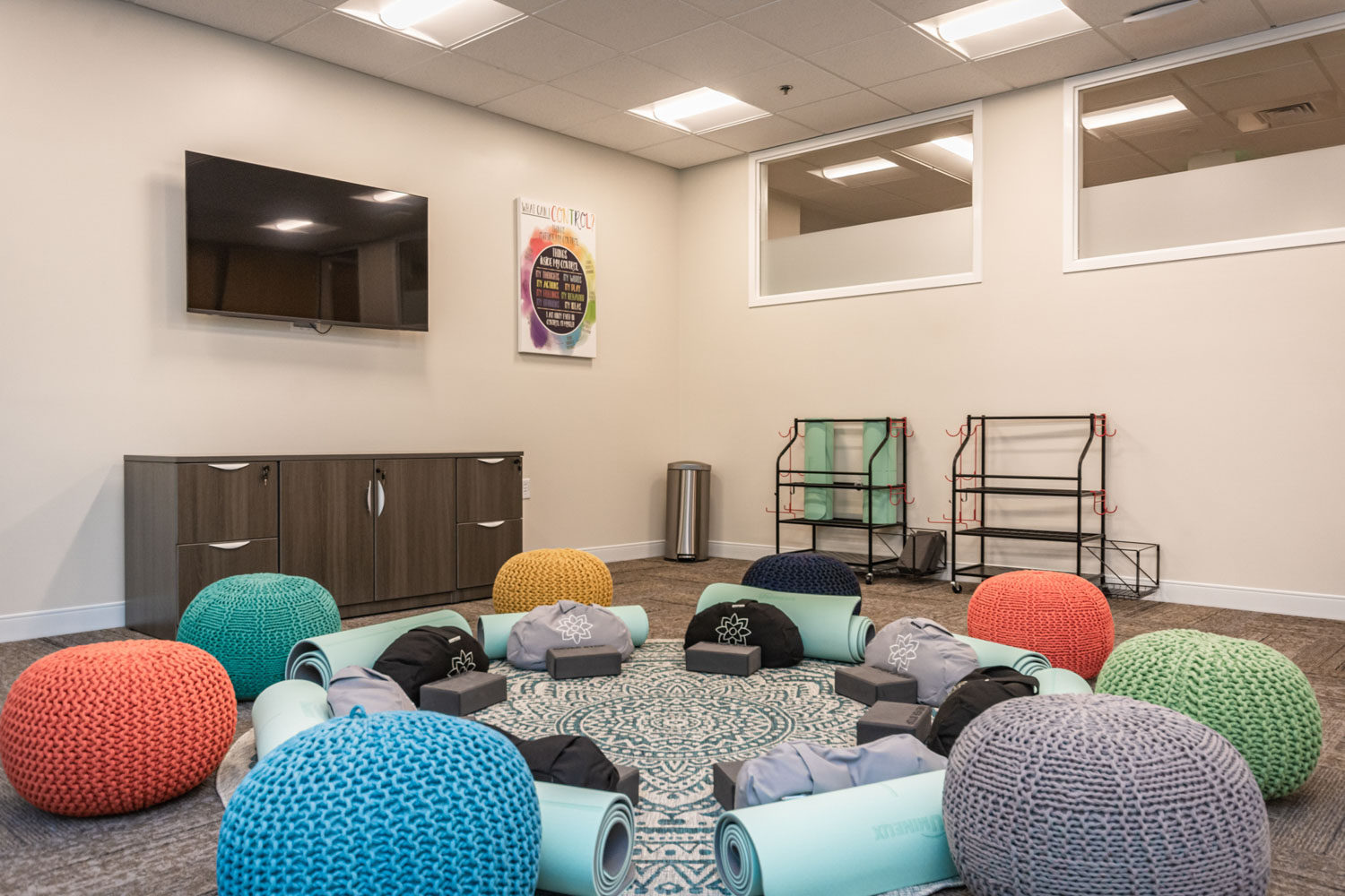 Yoga room with cushions and mats.