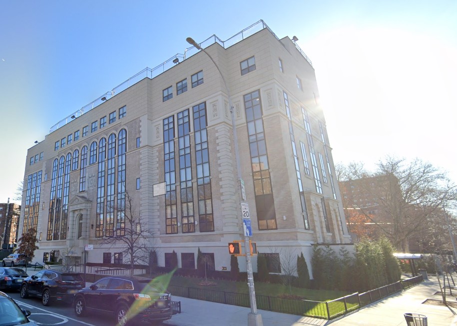 Side view of Addiction Care Interventions buiding with street parking.