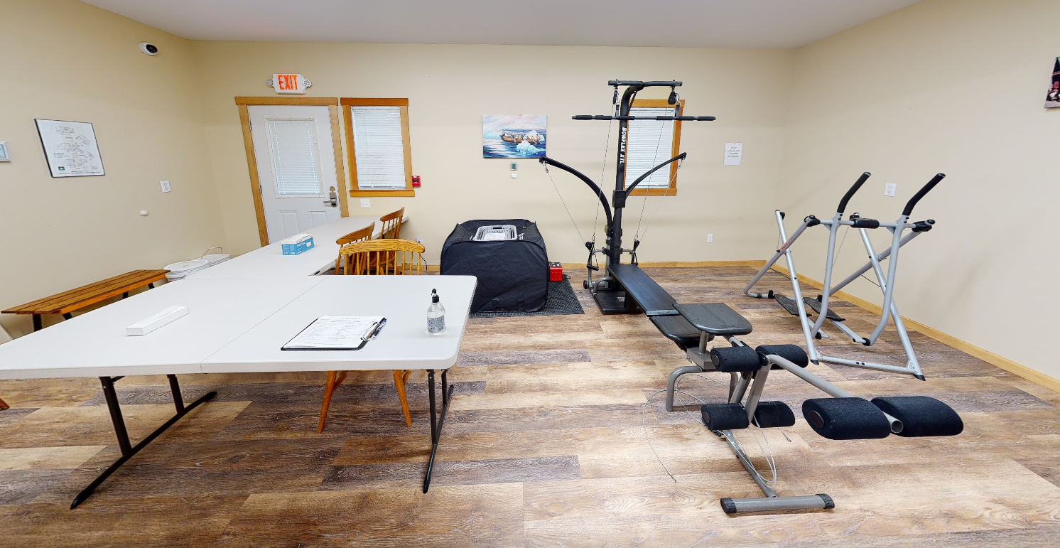 Exercise area with strength equipment and open floor space