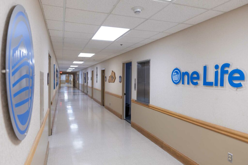 Long hallway with facility signage on wall