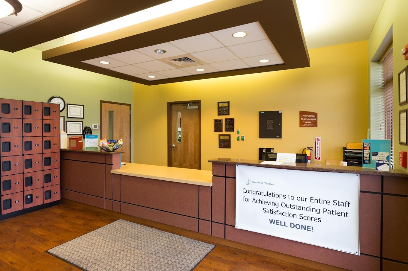Rehab reception desk with lockers and staff recognition banner