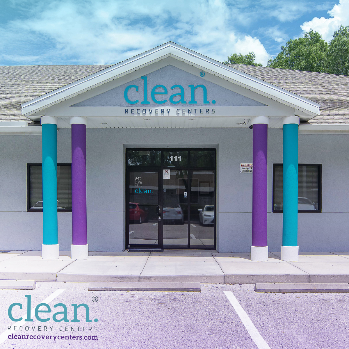 Exterior of Clean Recovery Centers building in Tampa, Florida, with colorful teal and purple columns and glass door entrance