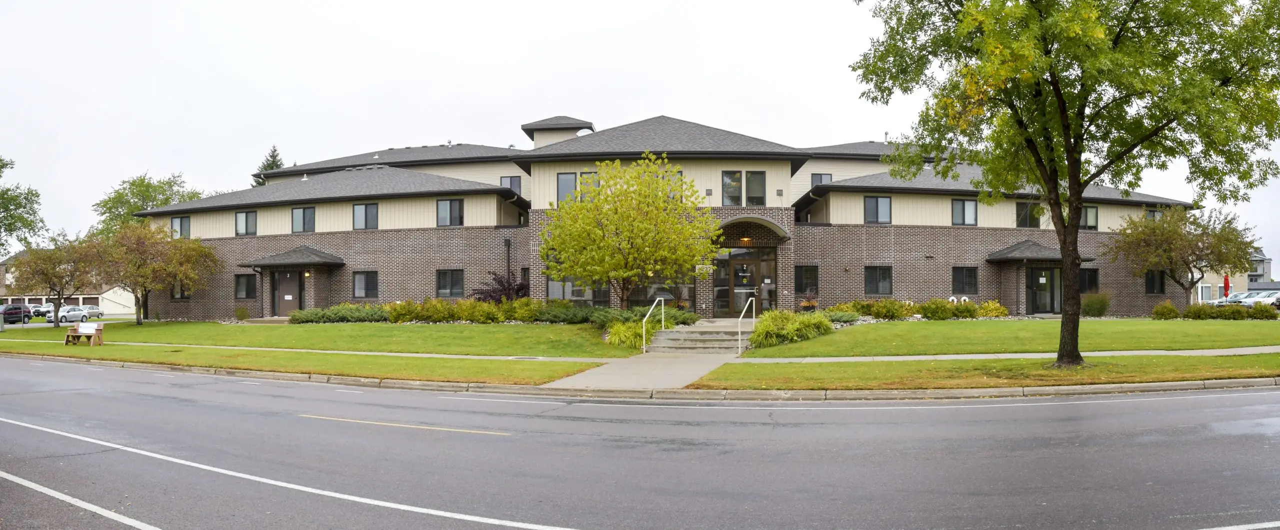 Large rehab facility with brick walls and green lawn