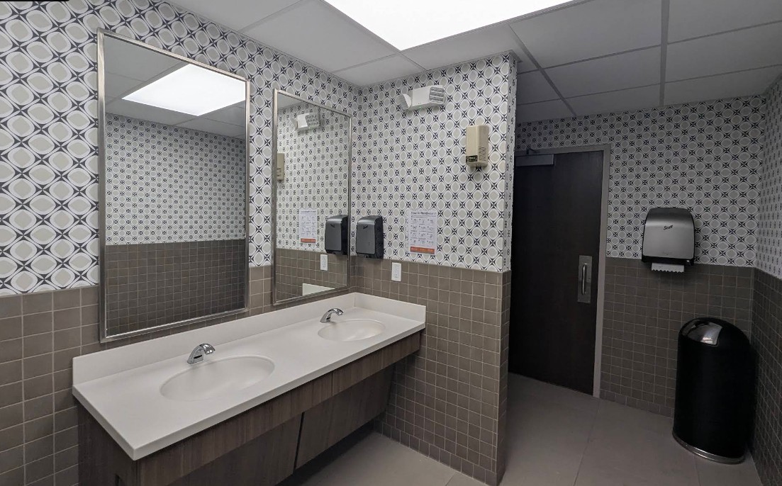 Clean restroom with sinks and accessible stall