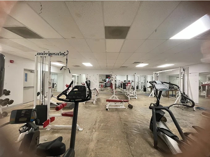 Gym with exercise bikes, weights, and training machines
