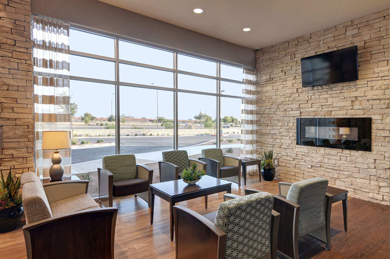 Modern lounge with fireplace and seating near large windows