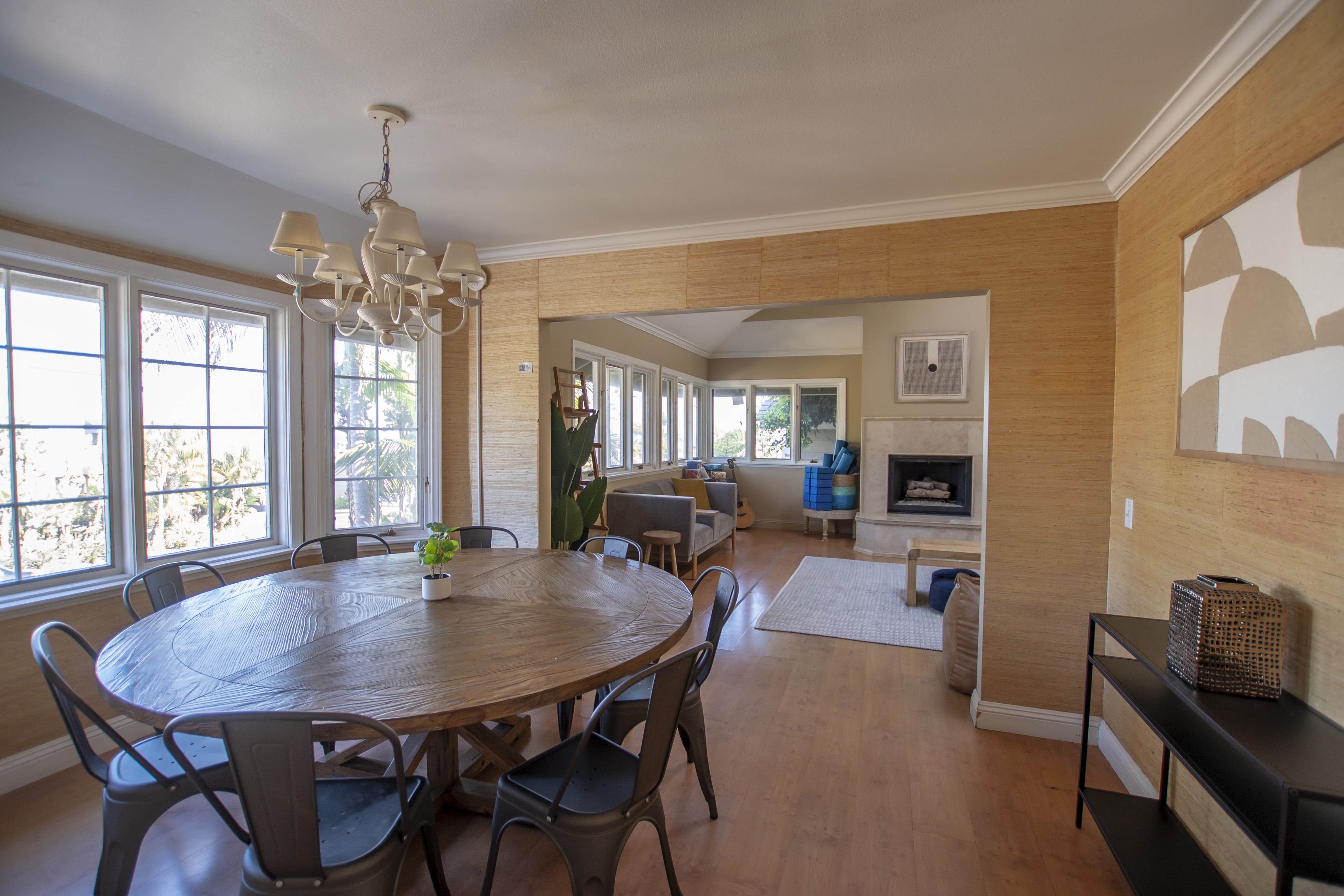 Round dining table in sunlit room with windows