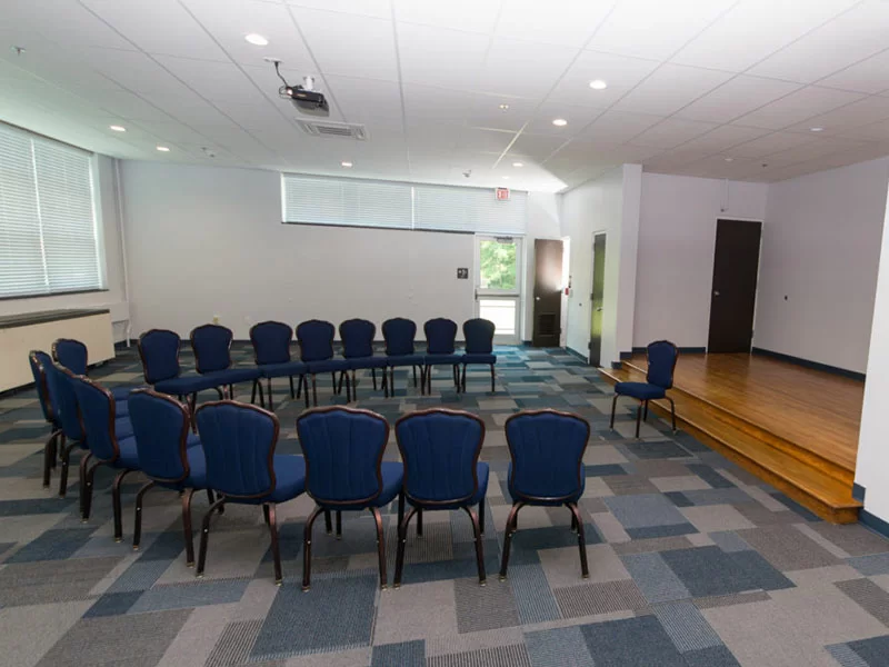 Therapy room with chairs in a circle and stage