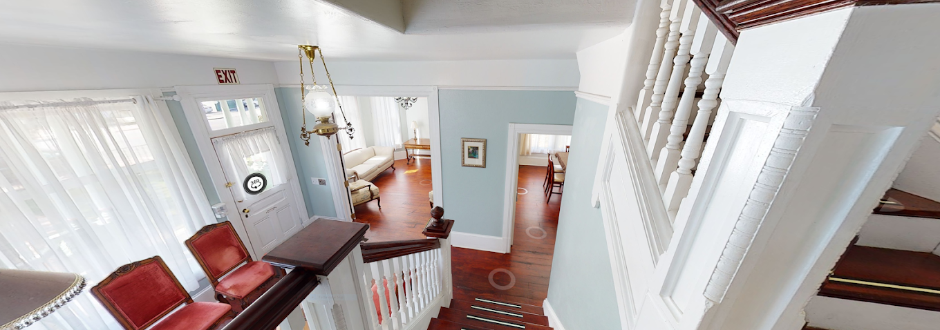 Interior staircase with wood floors and open hallway