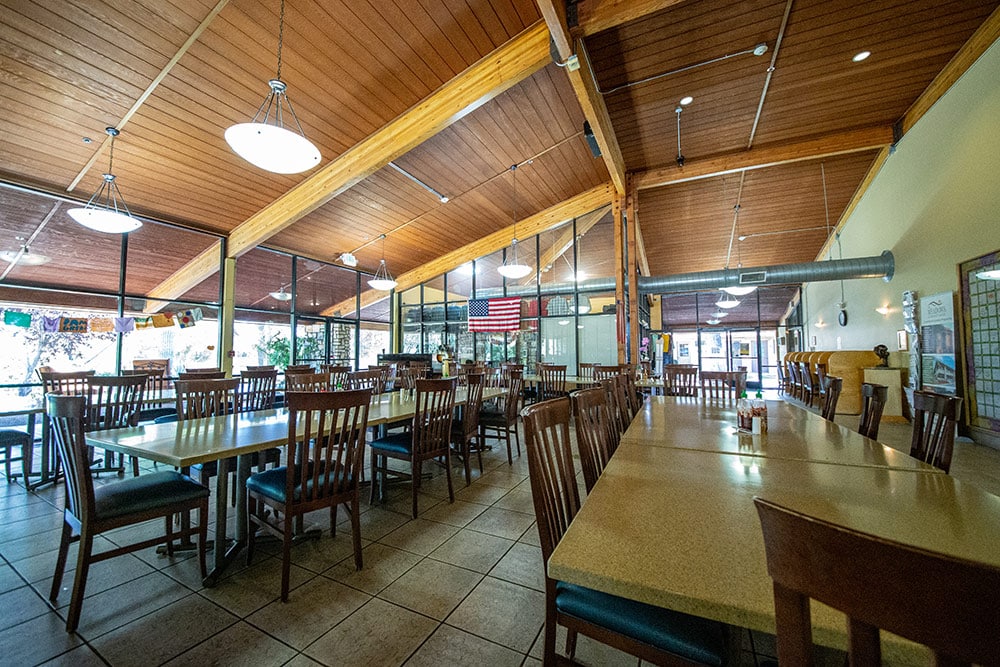 Spacious dining hall with tables, chairs, and large windows