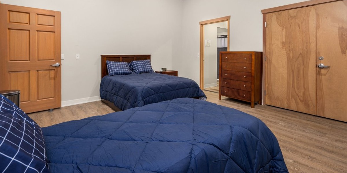 Shared bedroom with twin beds and wooden furniture