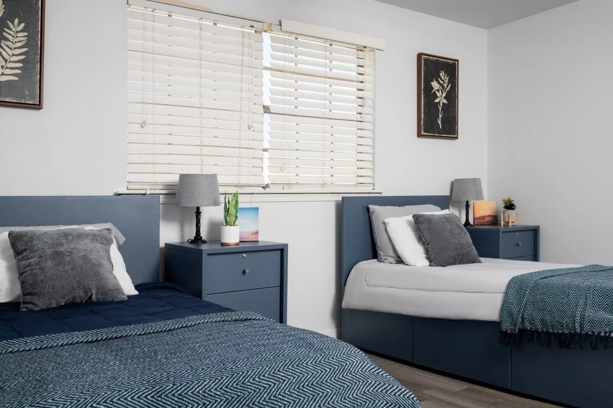 Neatly arranged shared bedroom with twin beds and decor.