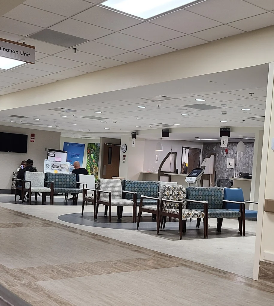 Waiting room with chairs and check-in desks labeled A to C