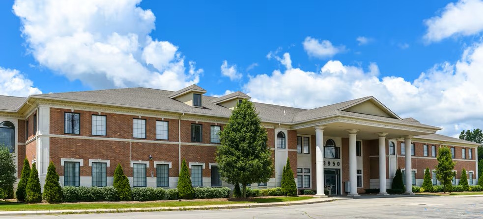Street-facing view of brick facility with white trim and main entrance