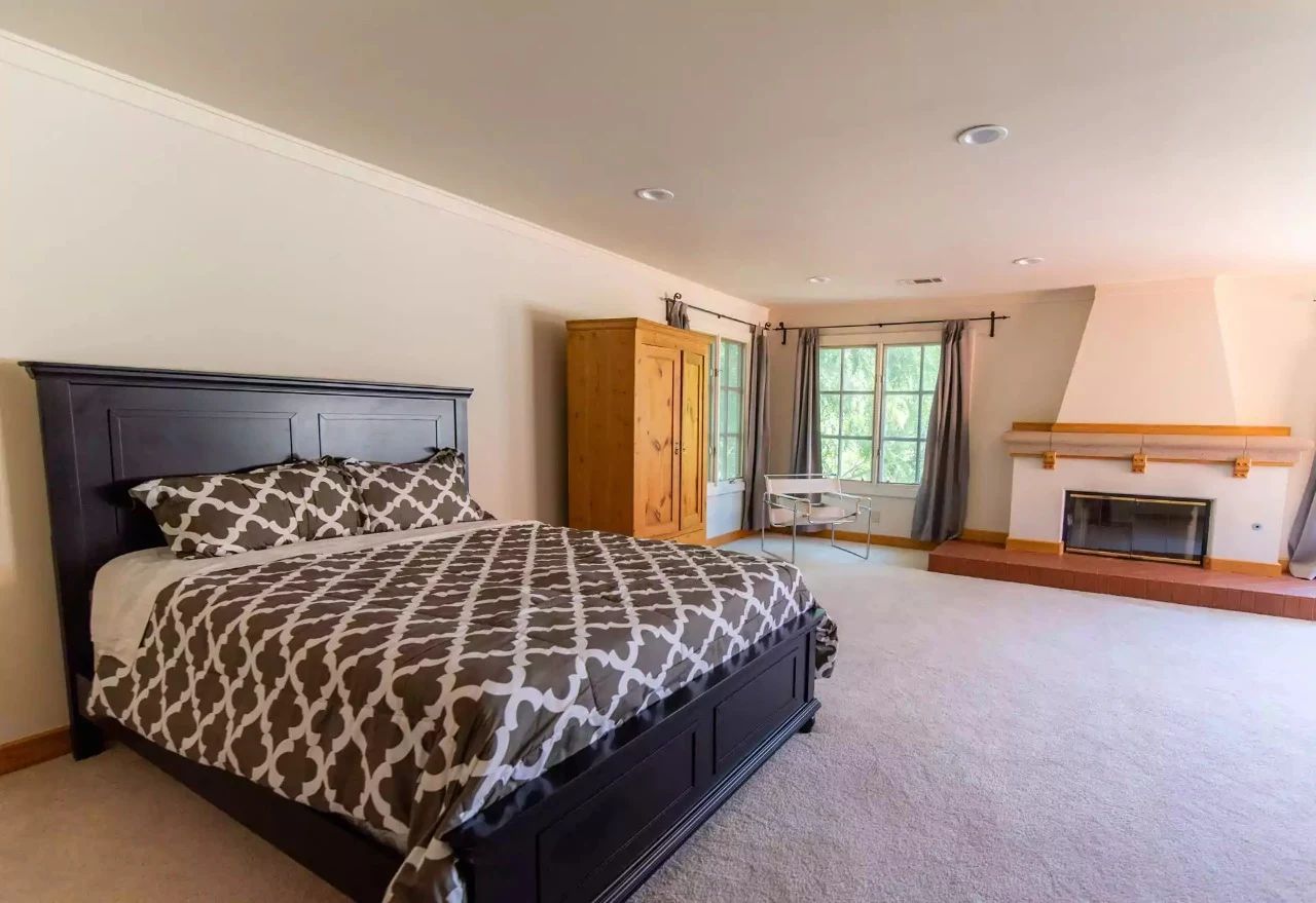 Private bedroom with large bed and fireplace