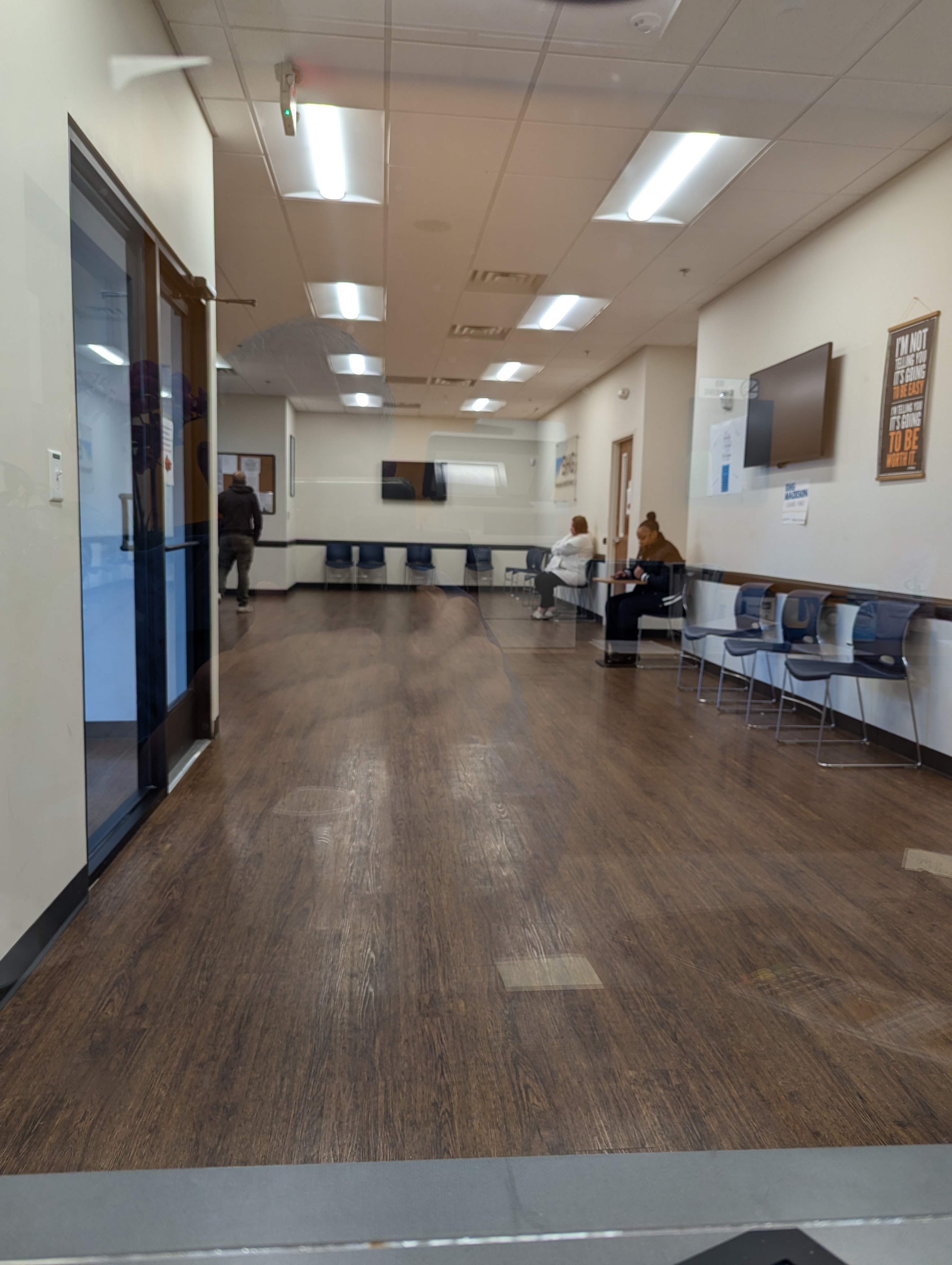 Waiting room with seating and wall-mounted television