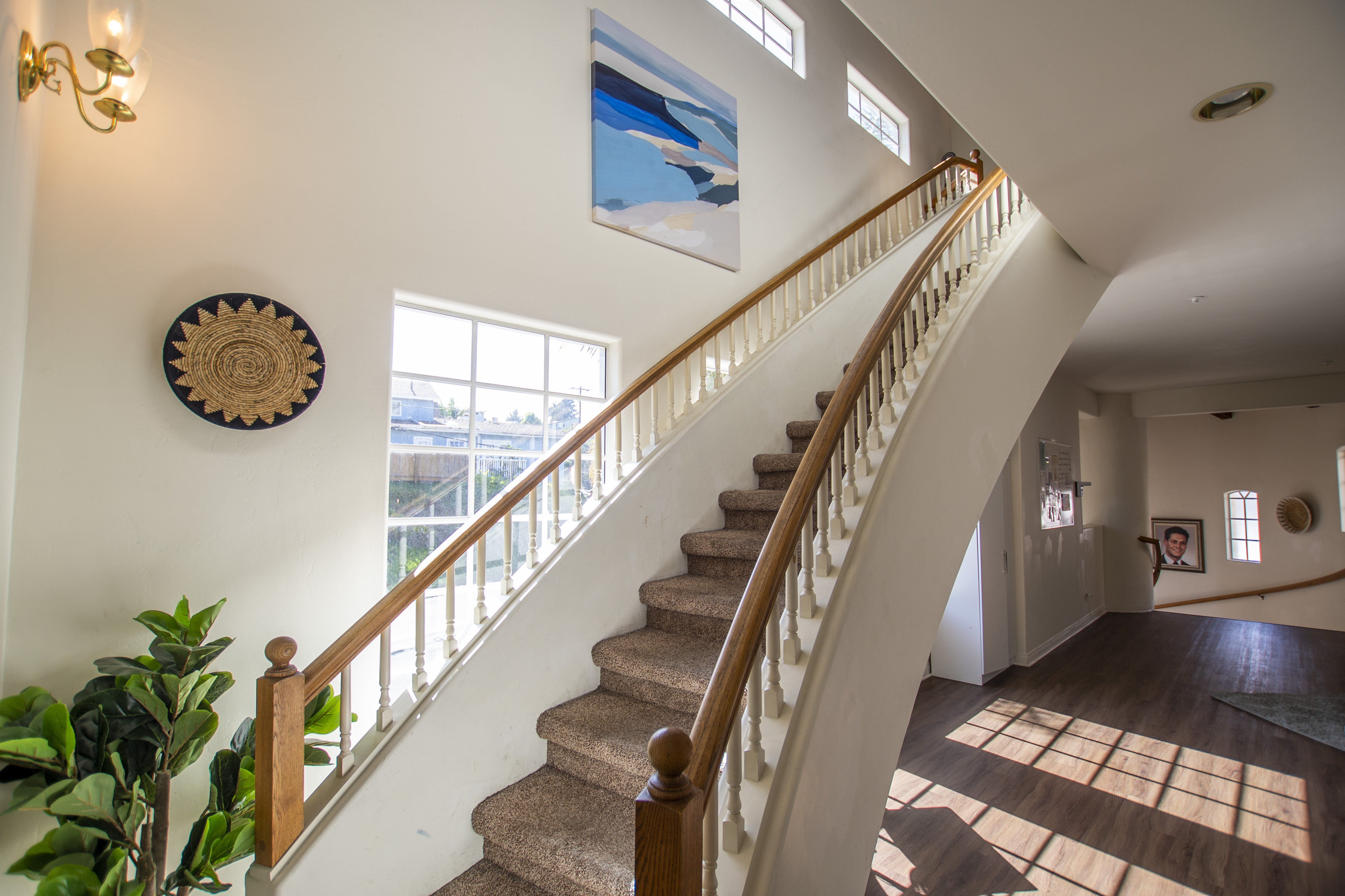 Curved staircase with natural light and modern decor