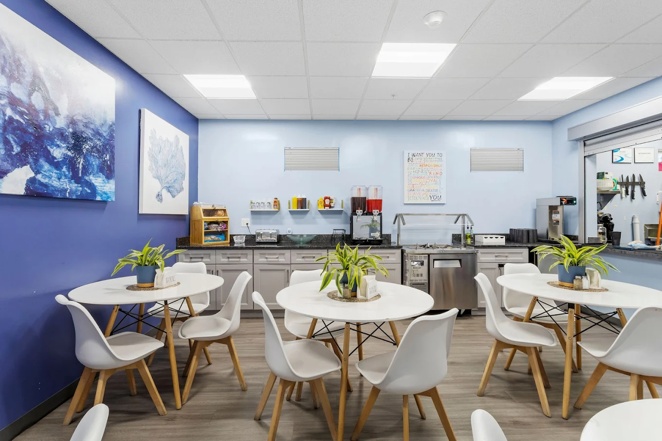Tables and chairs arranged in a casual dining setting with snack station and decor