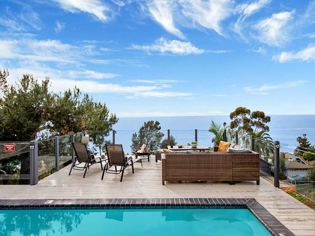 Pool deck with ocean-view seating and fire pit