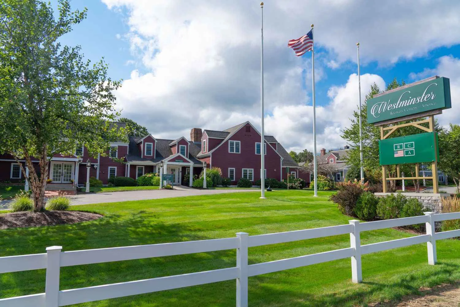 Center exterior with driveway by entrance with signage.