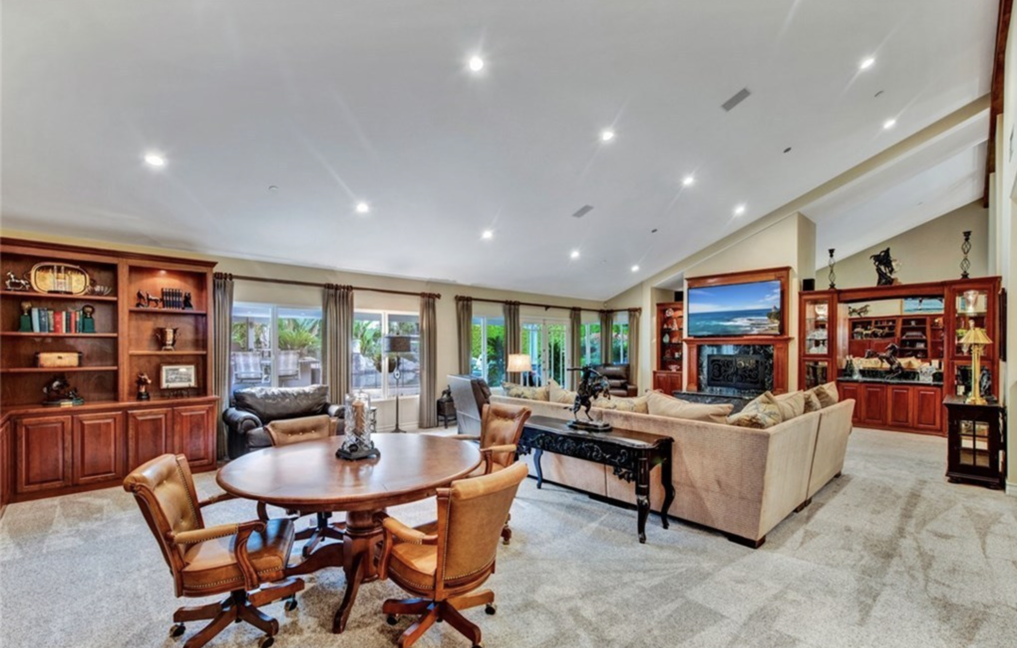 Living room with seating, a fireplace and TV.