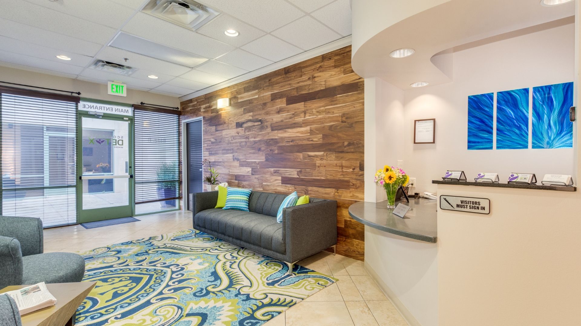 Waiting area with seating by the reception.