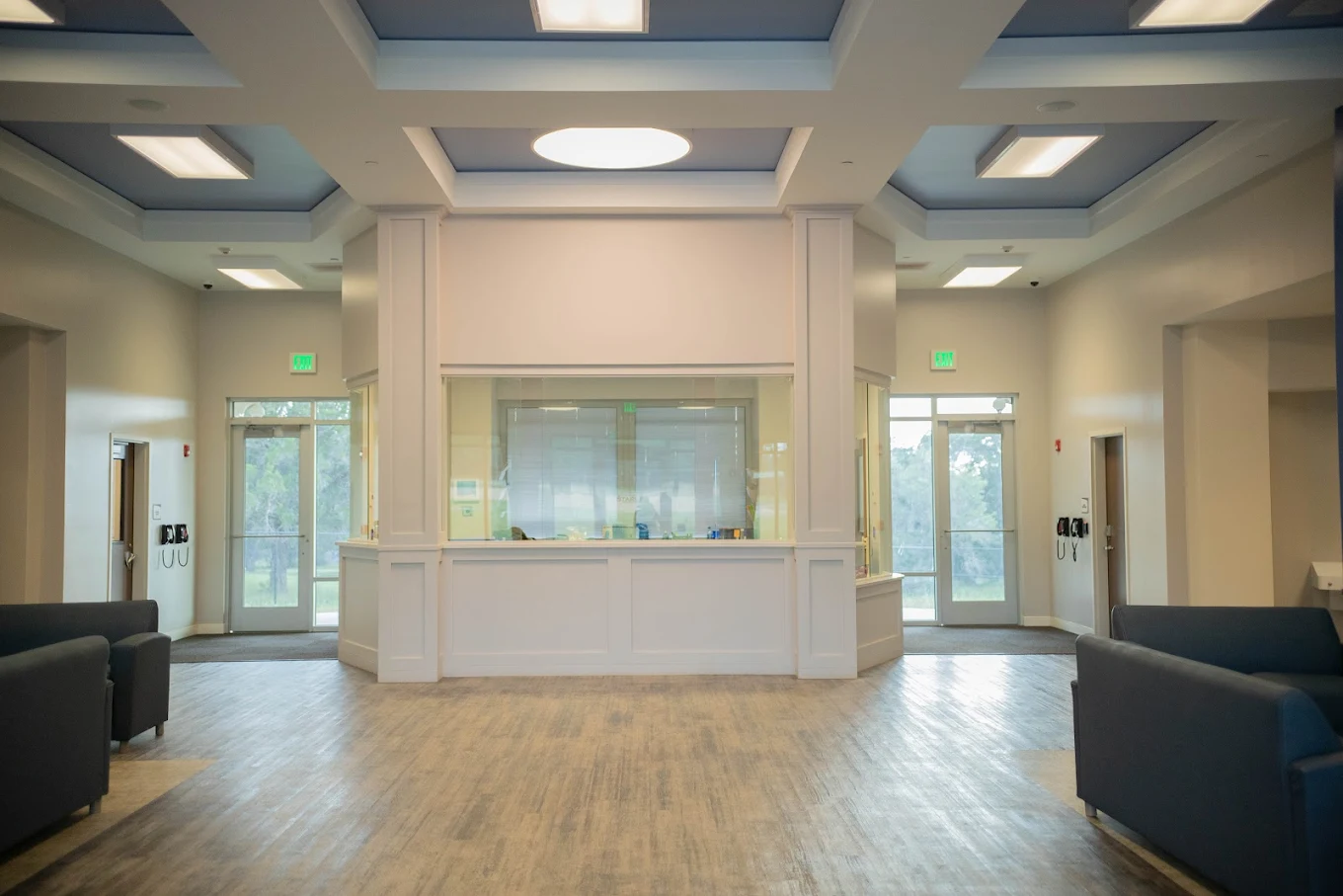 Bright lobby with central desk and blue ceiling inlay