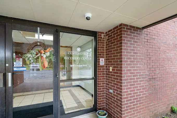 Glass door entrance to Centerstone Recovery Center with brick exterior and seasonal wreath.