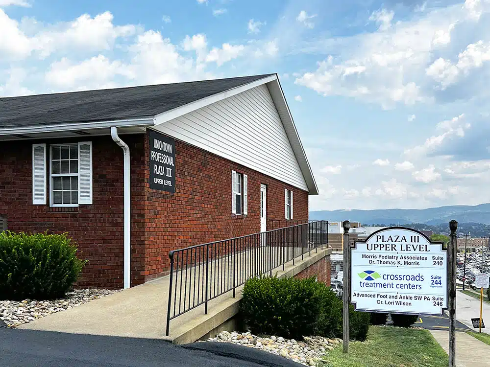 Brick clinic building with ramp and Plaza III sign