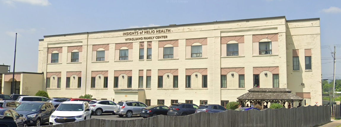 Side angle of Helio Health building and parking area