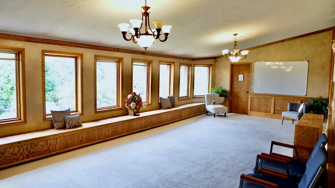 Therapy room with cushioned benches and whiteboard