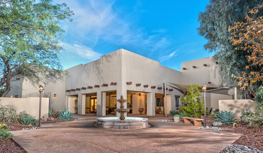 Desert-style courtyard with fountain and adobe buildings