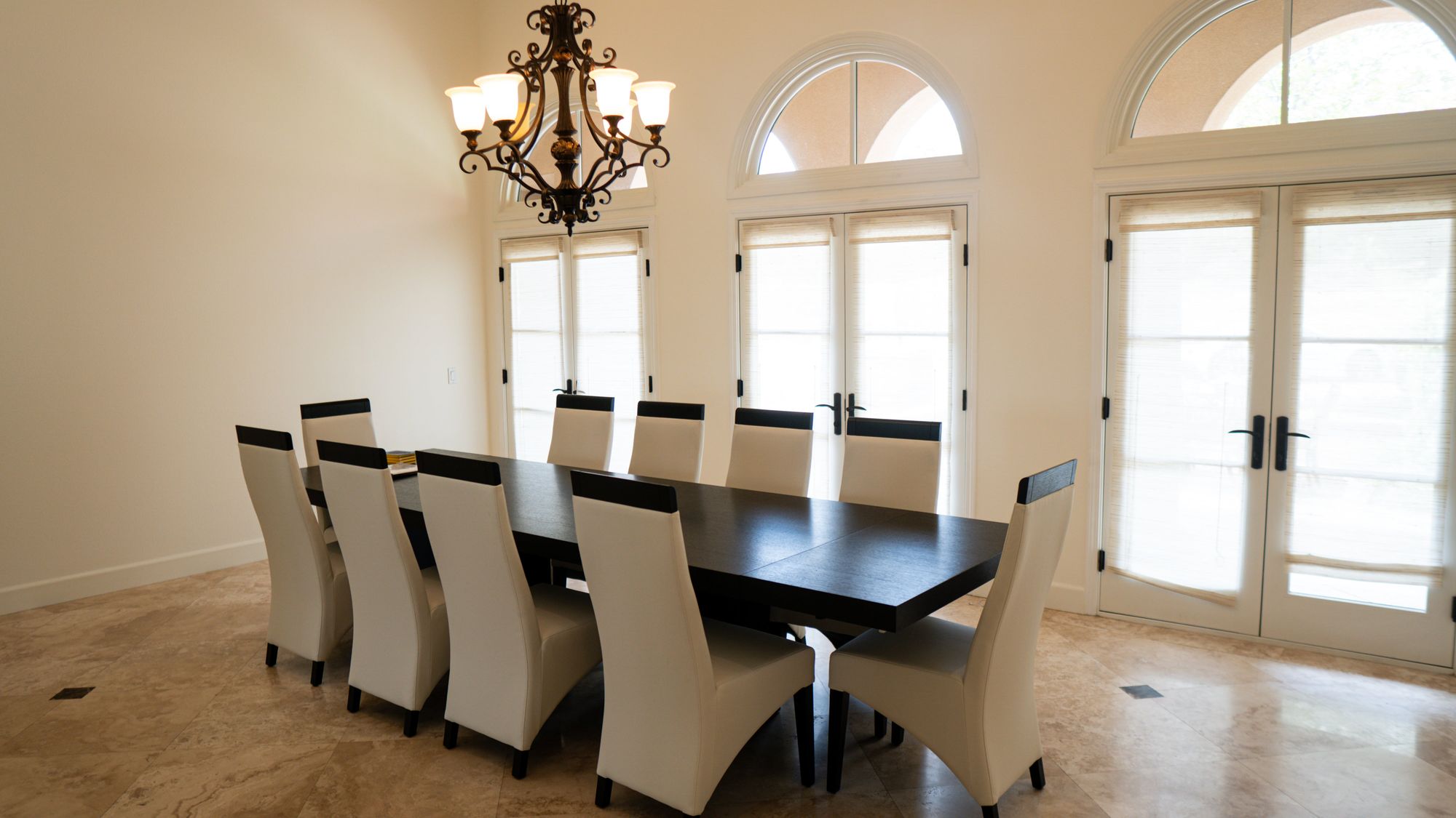 Elegant dining room with long table and upholstered chairs