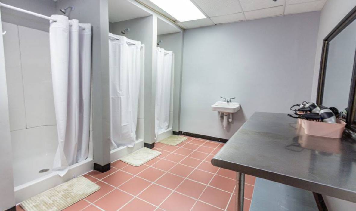 Shared bathroom with multiple private shower stalls