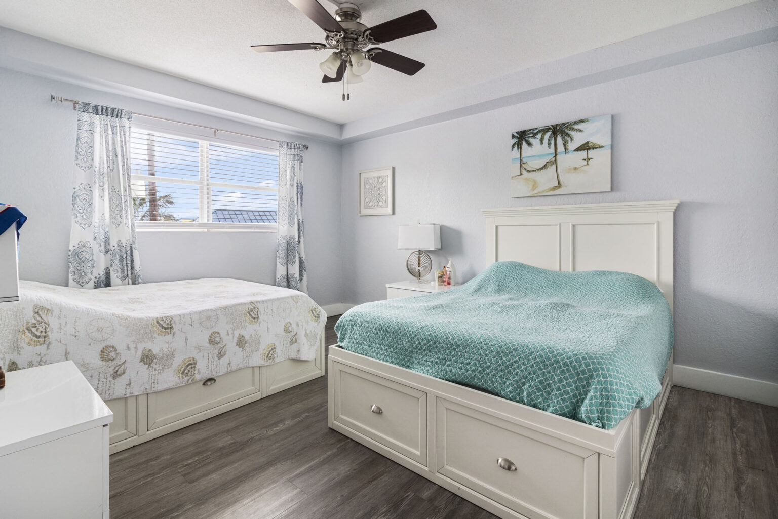 Room with two beds and large window