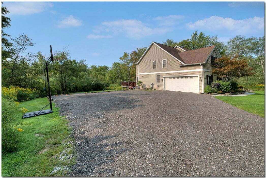 Outdoor basketball court beside wooded area